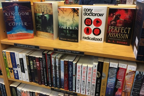 Bookshelf with prominent SFF titles face-out